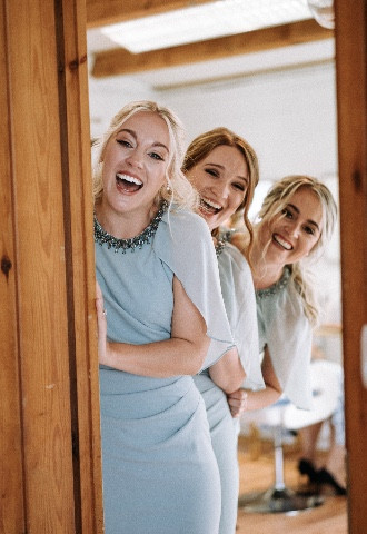 bridesmaids laughing and smiling with hair and makeup 