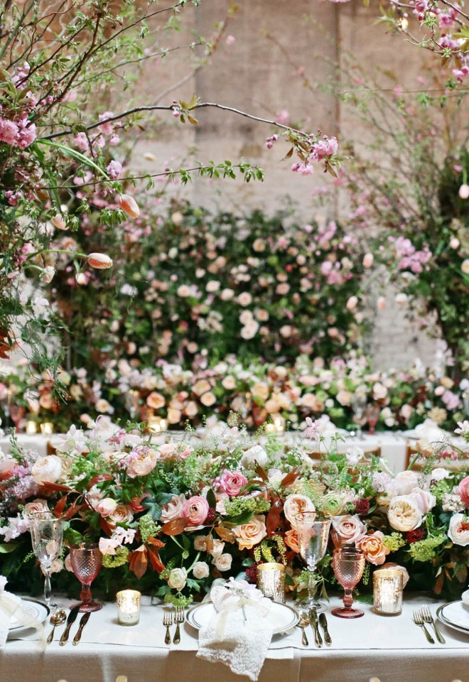 Spring wedding tables with luxury floral garland and flower "trees" of blossom, roses, ranunculus, hellebores, tulips, sweet pea and lilac, London