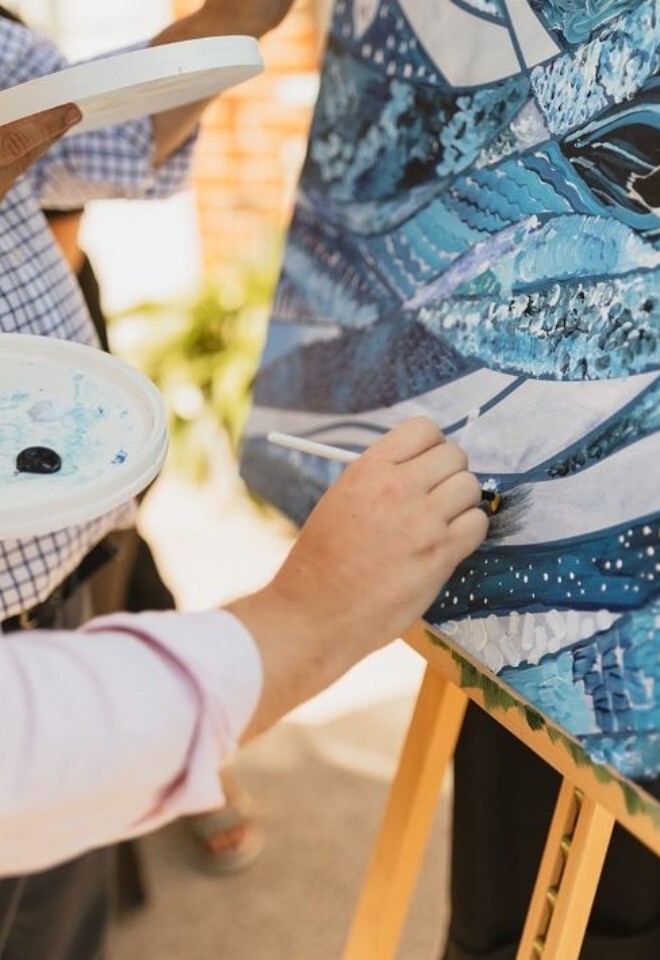 guest painting at wedding