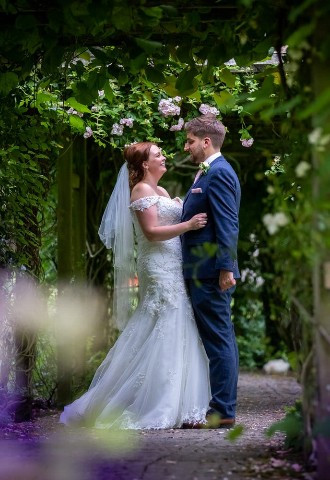 Bride and groom in the gardens at Margam Orangery, Neath Port Talbot