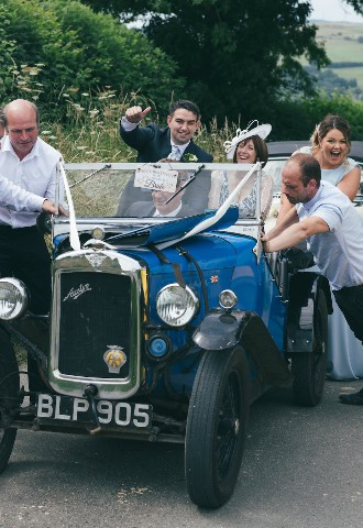 bridal car broken down on way to wedding as wedding guests help push it along north wales flintshire