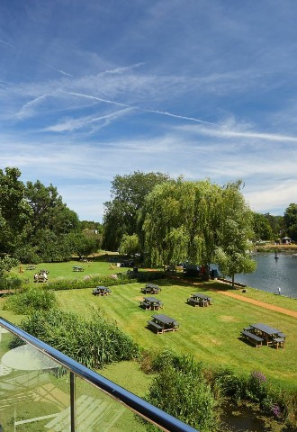 Balcony view of the grounds and riverside at The Swan at Streatley in Berkshire.