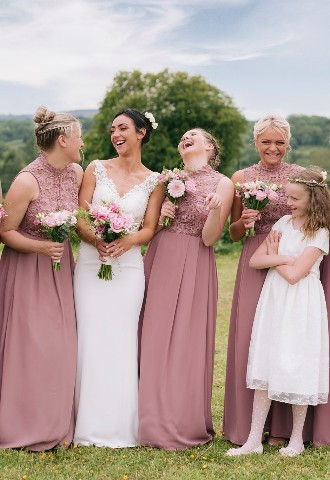 bride and bridesmaid sharing a laugh on her wedding day, north wales wedding photography andrew baines photography