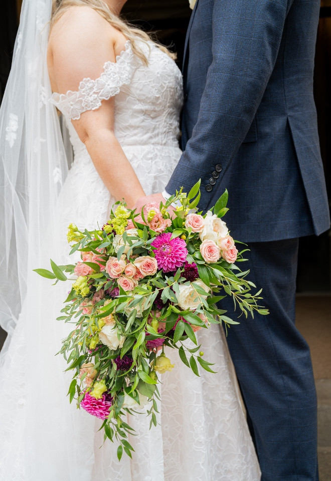 Bouquet details with bride and groom taken by WinCo Photography 