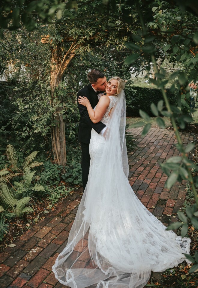 Bride and groom in the gardens of their wedding venue, Alfrison Gardens