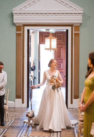 Bride and her dog walking down the aisle
