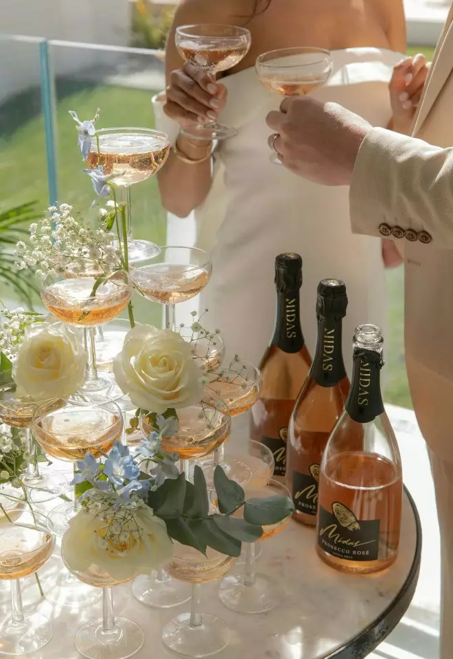 Happy couple at prosecco tower at The Nici, Bournemouth wedding venue, Dorset