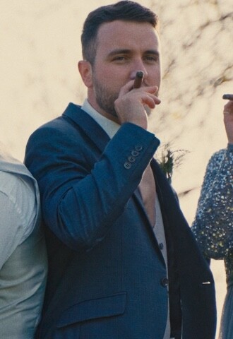 groom and best man smoking cigar