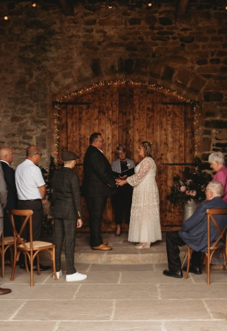 Rustic farm barn wedding ceremony with congregation Yorkshire