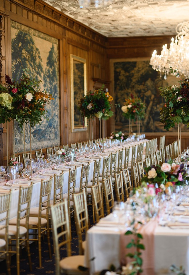 Elevated floral designs with compote bowls and bud vases of rich autumn flowers and foliage at North Mymms Park