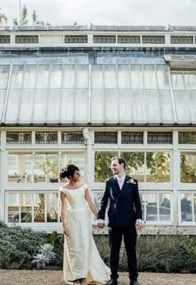 couple outside greenhouse in The Commissioners Garden