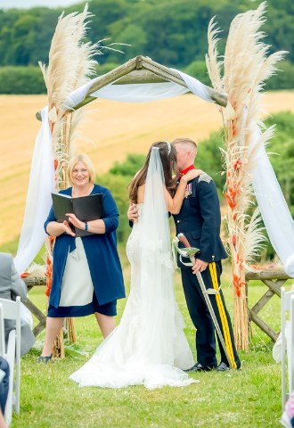 Outdoor wedding ceremony in the meadow at Monkton Barn wedding venue