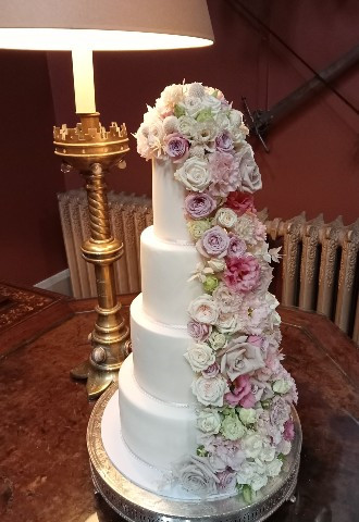 Tiered wedding cake with cascading sugar flowers from Gails Cake Pantry South Wales