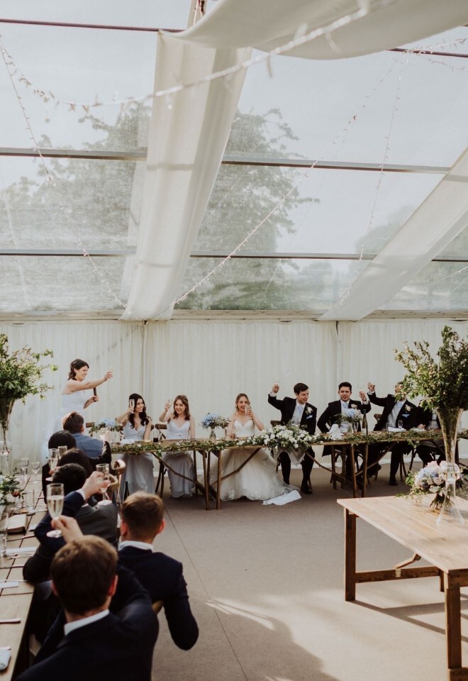Marquee wedding reception with foliage centrepieces and top table styling at Somerset wedding by FLOWERS BY ANYA