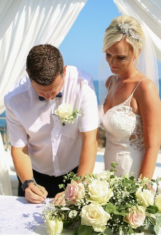 Bride and Groom signing the register at the wedding ceremony on a yacht in cyprus, exclusive yacht weddings