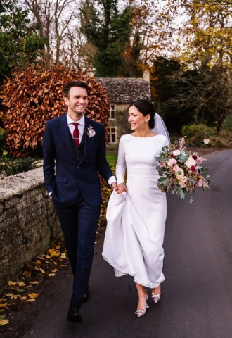 Couple walk together on their wedding day close to their wedding venue, Wild Thyme & Honey