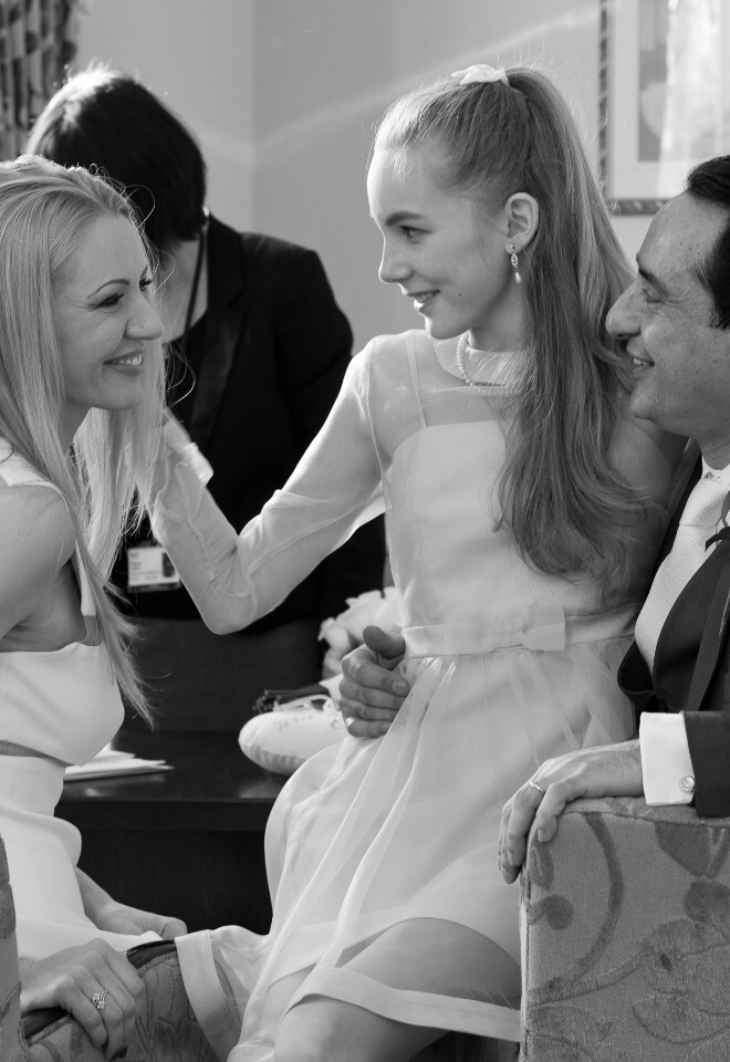 Candid wedding image in black and white of daughter with mother and her new husband
