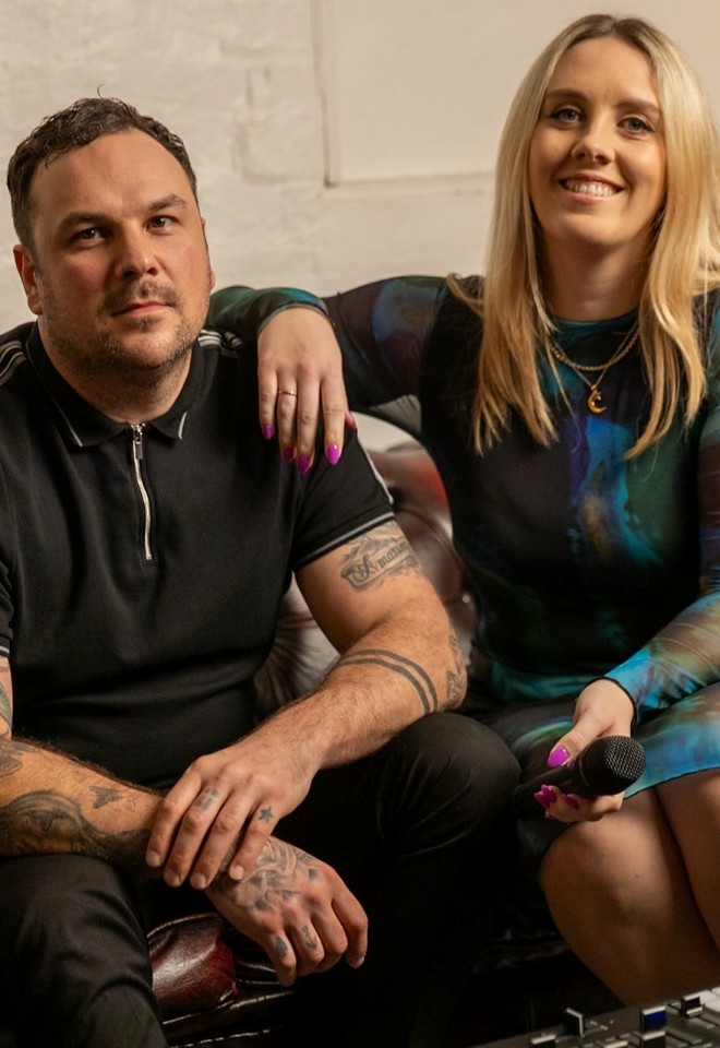 Josh & Nora sitting on a sofa