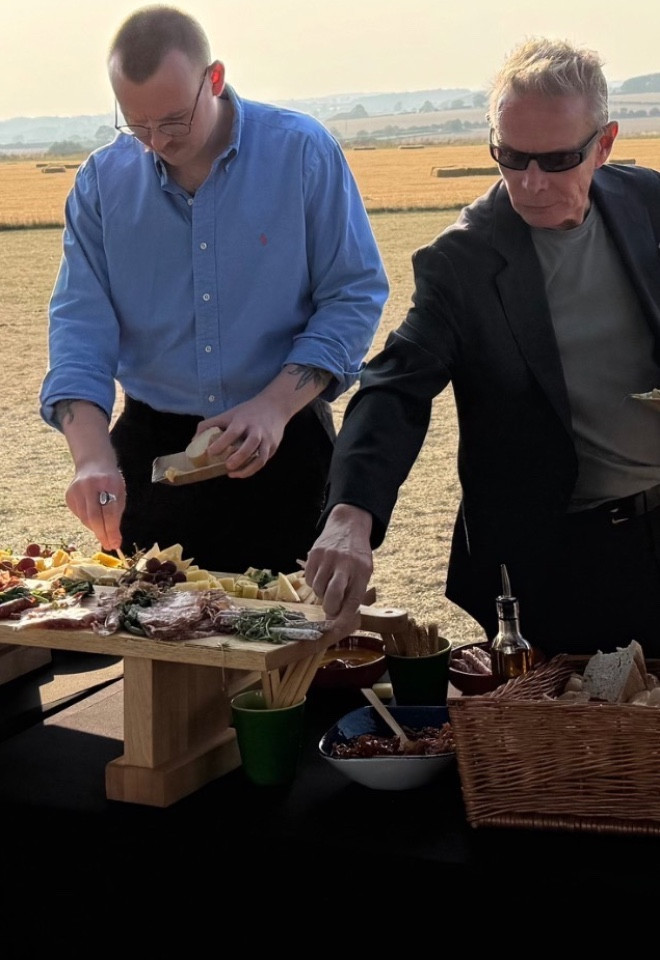 Guests enjoying a hog roast and BBQ catering at an outdoor event