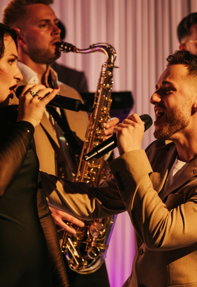Two singers interact while performing