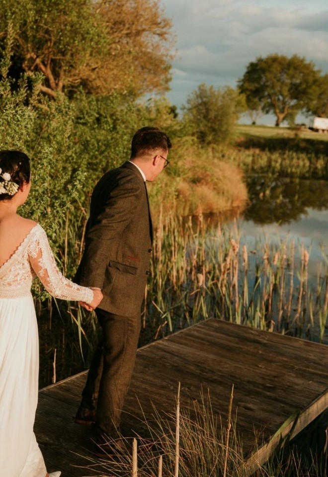 The happy couple having their moment overlooking the water. at golden hour.