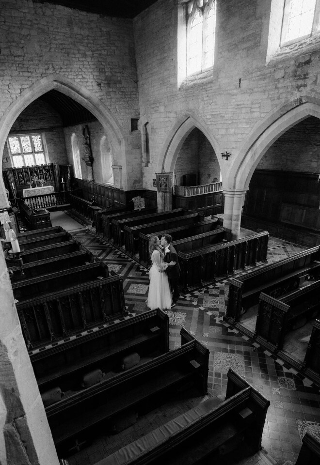 Black and white image showing a couple inside Buckland Manor church