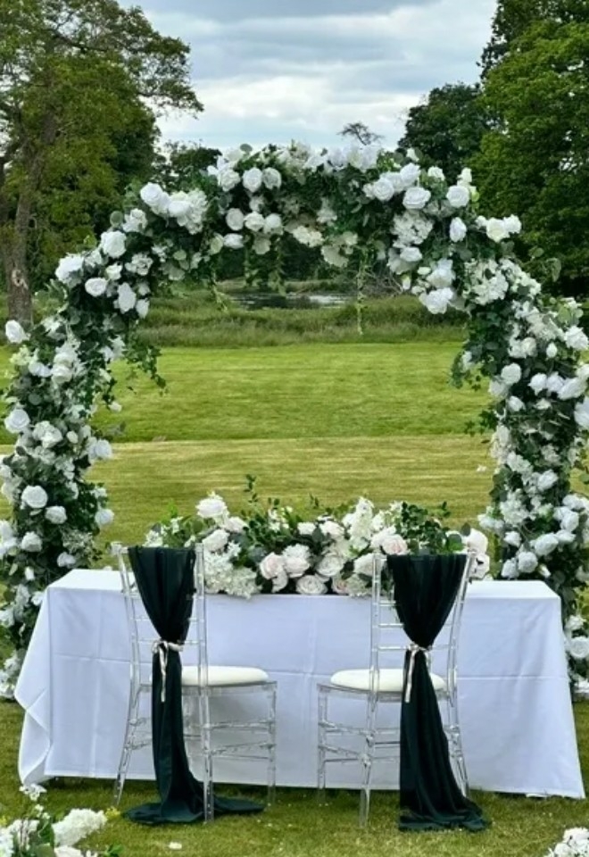 floral archway with table for wedding couple