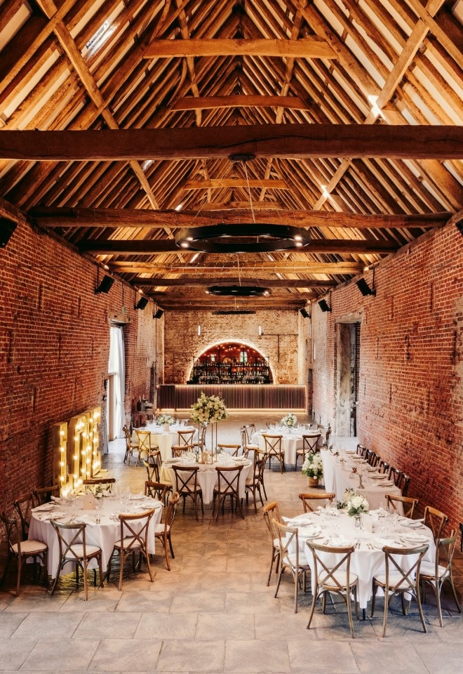 Interior of the Elizabethan Barn at Copdock Hall set for a wedding breakfast
