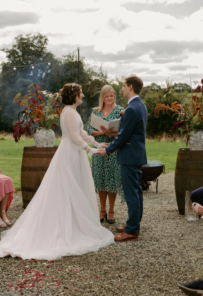 Celebrant leading an outdoor ceremony at a country house