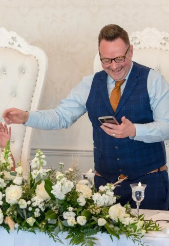 Bride and groom share a laugh during the speeches at Coed Y Mwstwr hotel, Bridgend