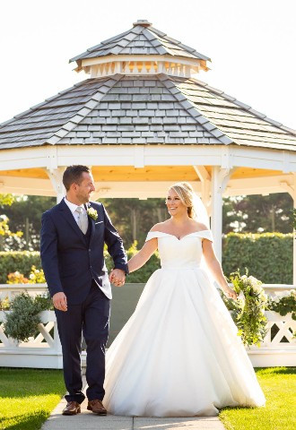 bride and groom posing for their wedding photography outside the wedding gazebo at The Lawn, Rochford, Essex