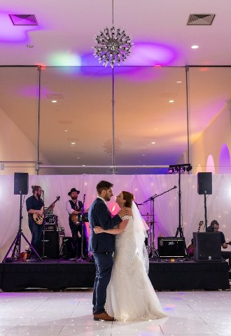 Bride and groom share their first dance at Margam Orangery, South Wales