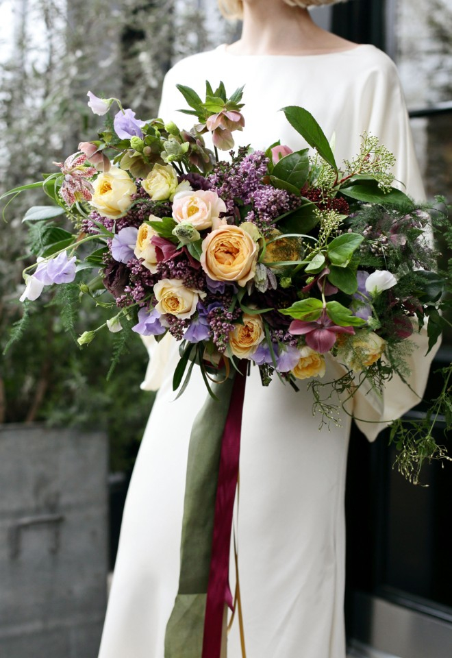 Luxury bridal bouquet of garden roses, lilac, sweet peas, hellebores and winter foliages for ceremony at Britxon, London