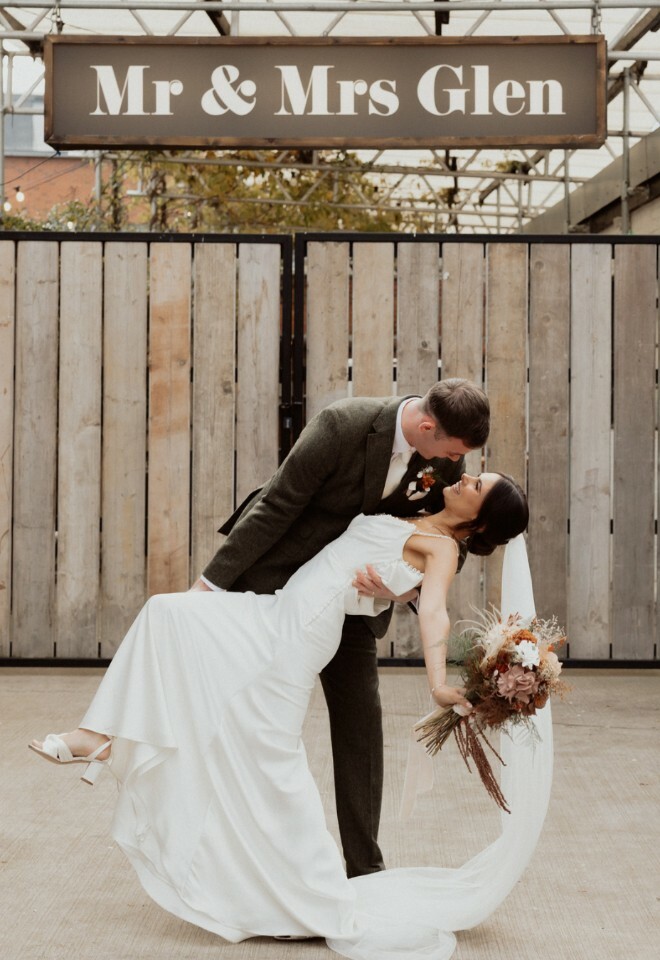 Couple posing in front of personalised lightbox