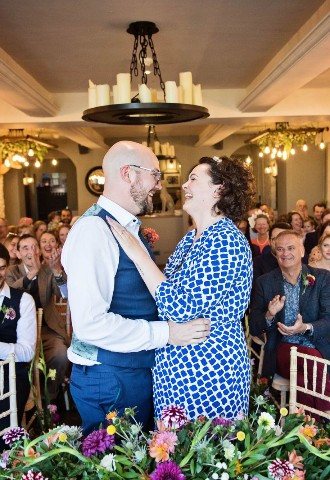 Bride and groom sharing a laugh after being pronounced man and wife at The Bay Tree Hotel, Burford, Oxfordshire