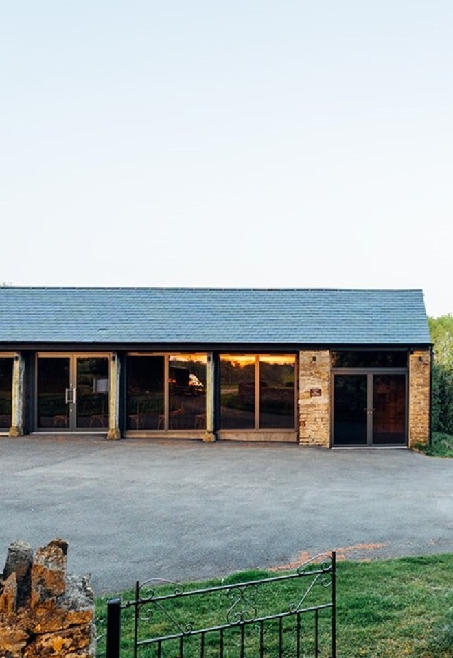 The grounds and barn at an exclusive Oxfordshire barn wedding venue