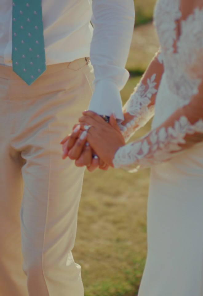 Bride and groom holding hands at Offley Place, Hertfordshire, captured by Dean Sherwood Wedding Films, Hertfordshire wedding videographer.