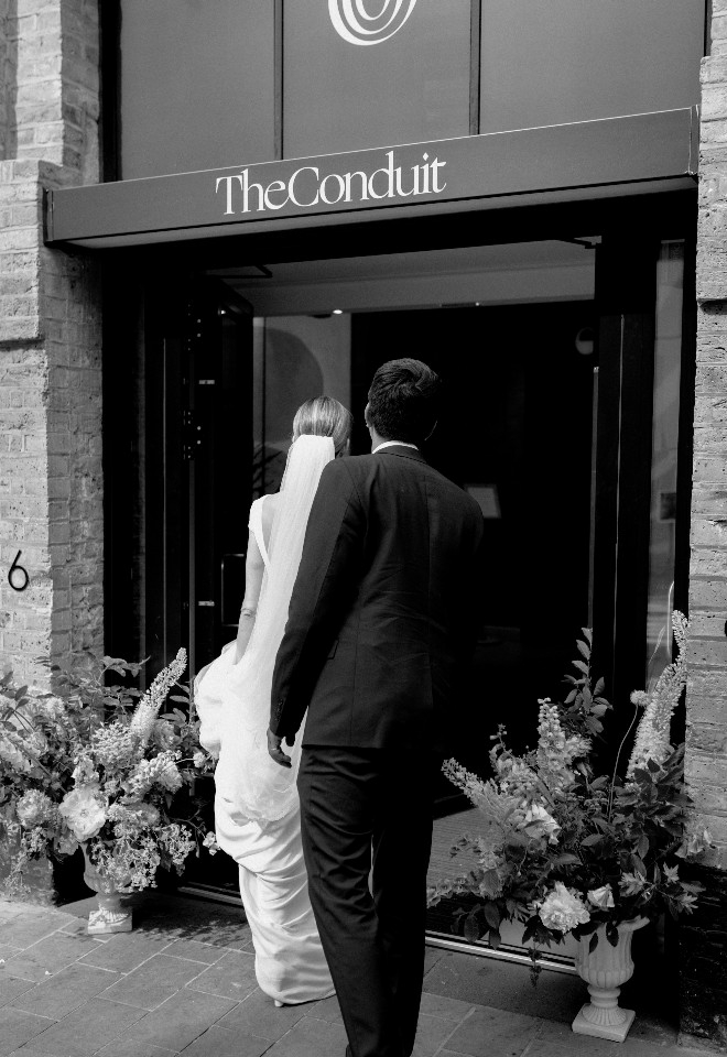 Couple arriving at their wedding reception at The Conduit Covent Garden