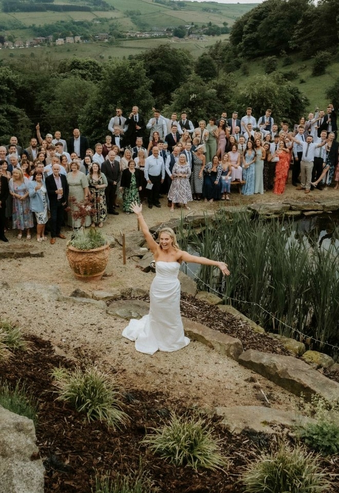 heart lake with bride surrounded by wedding guests at The Stables Wedding Farm