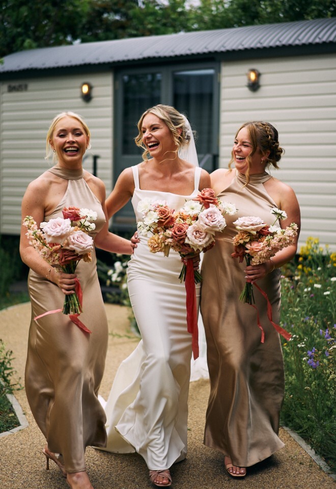 Bride and bridesmaids outside shepherds huts