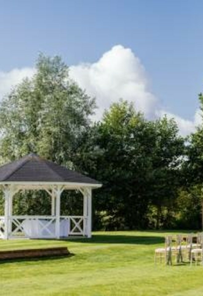 Outdoor ceremony at the pagoda with trees in the background- Sprowston Manor Norwich