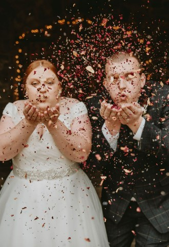 Wedding ceremony in stone barn with confetti
