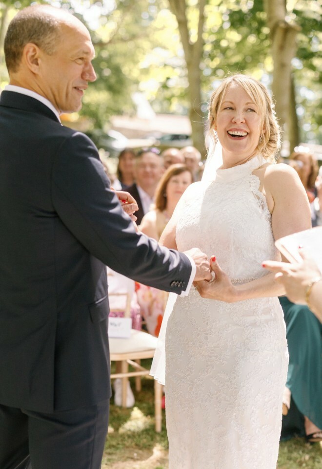couple happily laugh at something celebrant has said
