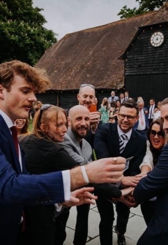 Nicky George performing magic at a wedding
