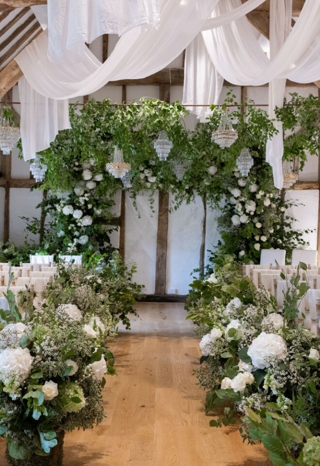 Impressive floral and decor inside wedding barn set for civil ceremony