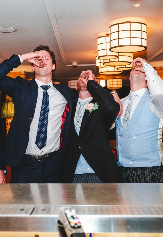 groomsmen drinking shots at bar