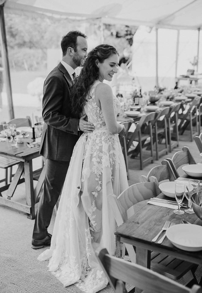 Couple in marquee looking at wedding decor