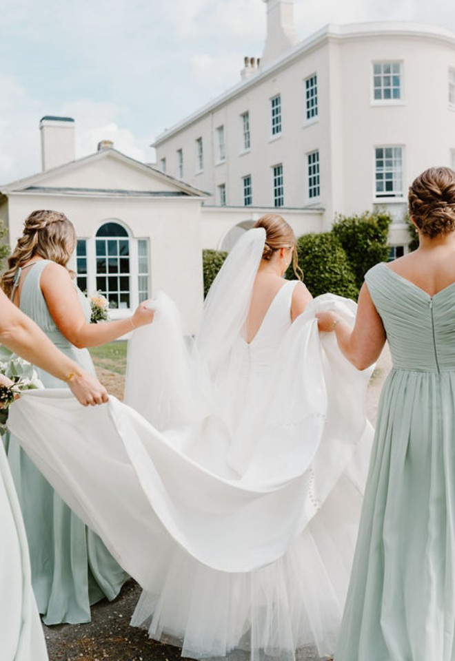 Bride Helped Along By Her Bridesmaids