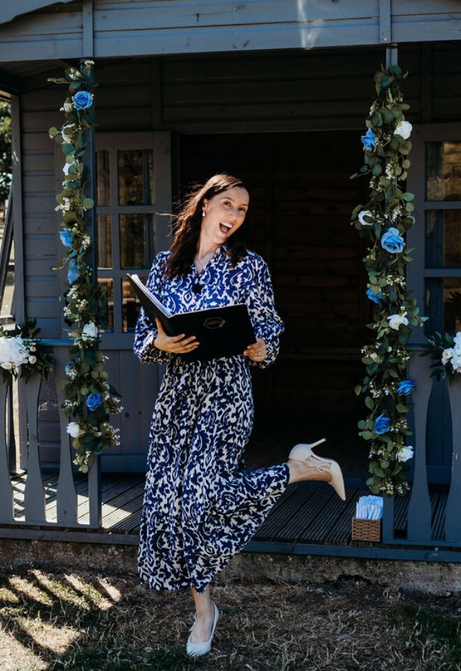 Fun and modern wedding celebrant posing before outdoor wedding ceremony