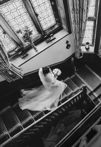 Bride on stairs at wedding at Wigfair Hall North Wales